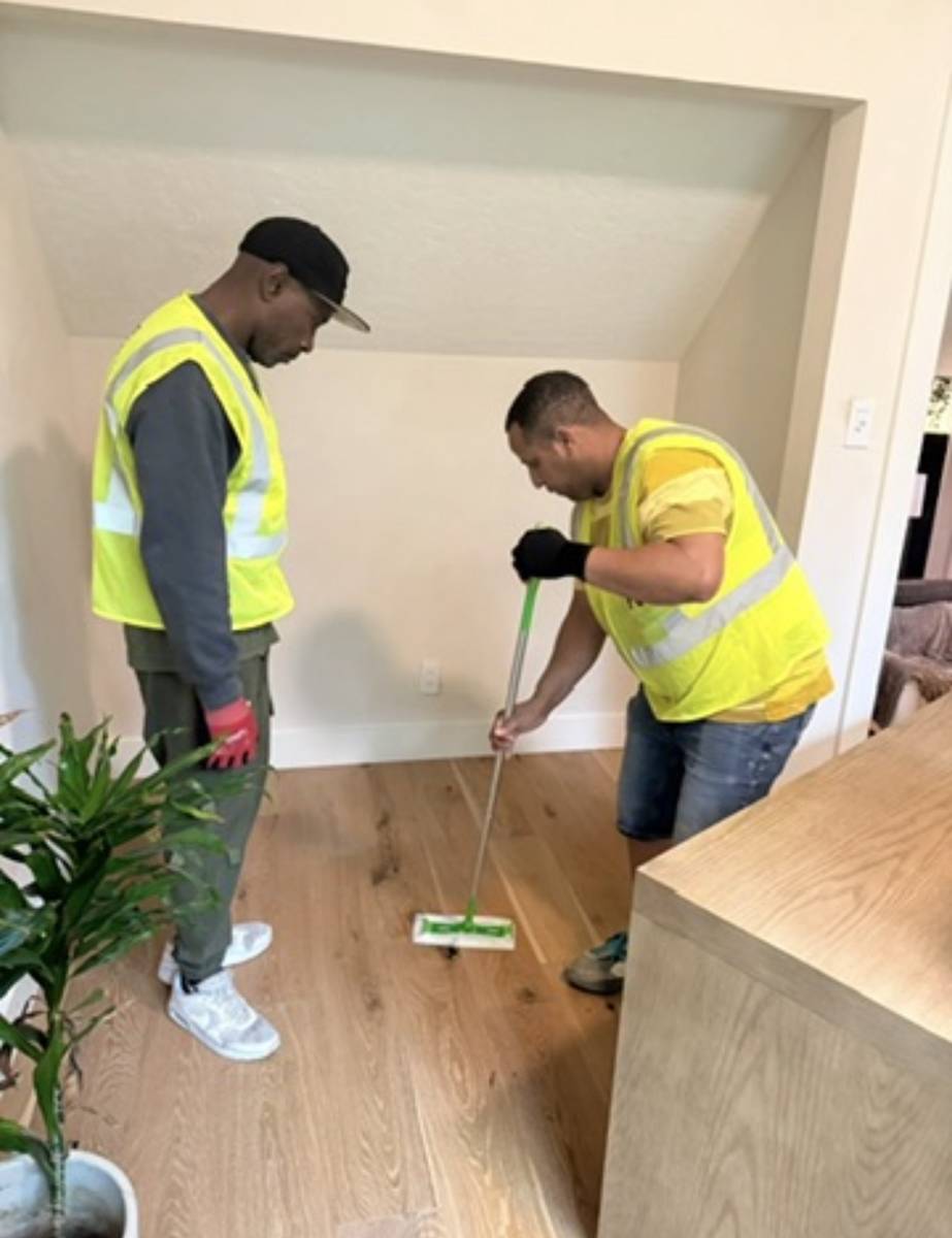 Movers laying down floor protection before a move