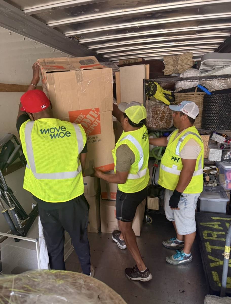 Movers loading boxes into the truck