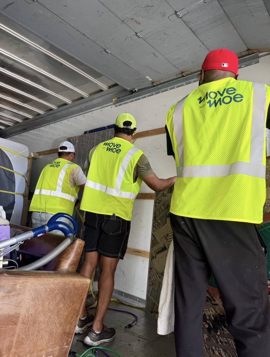 Movers stacking items tightly inside the truck