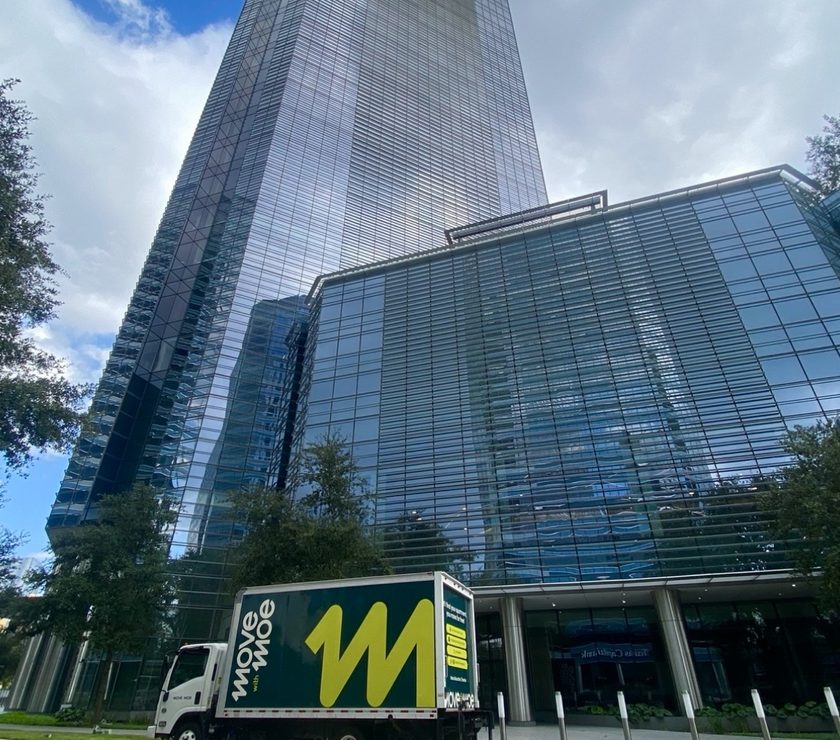 The Move with Moe truck outside a downtown Houston tower
