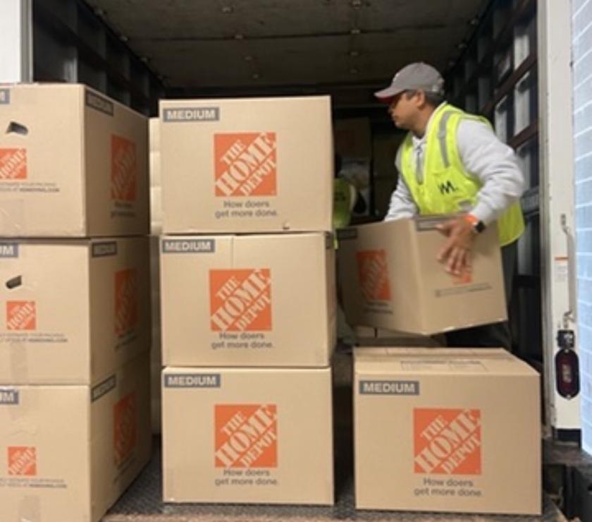 A mover stacking boxes neatly inside the truck