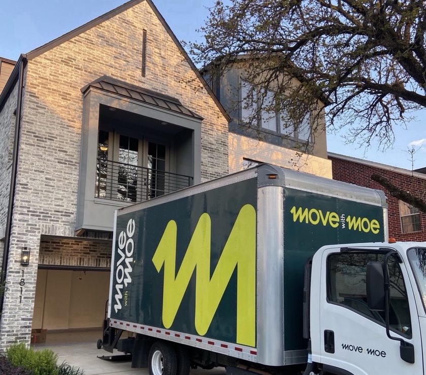 The Move with Moe truck parked at a two-story home